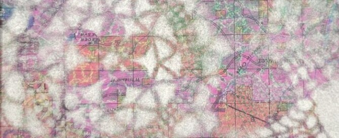 Doily monoprint on top of a map, white tones