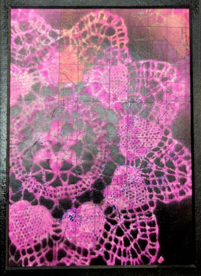 Doily monoprint on top of a map, black over hot pink.